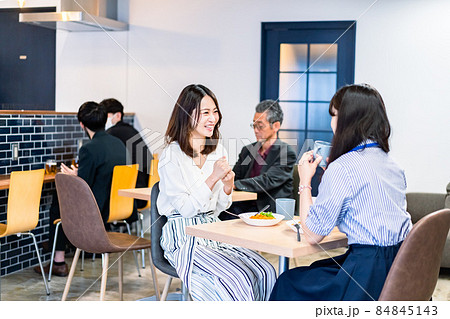 明るい雰囲気の社員食堂でランチを取るオフィスワーカー 84845143