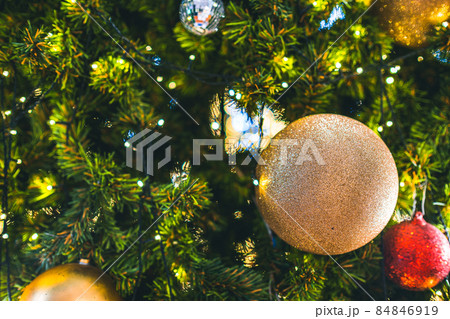 Merry x-mas,Close up of Colorful balls ,gifts box and Christmas greeting picture parcel decoration on Green Christmas tree background Decoration During Christmas and New Year. 84846919