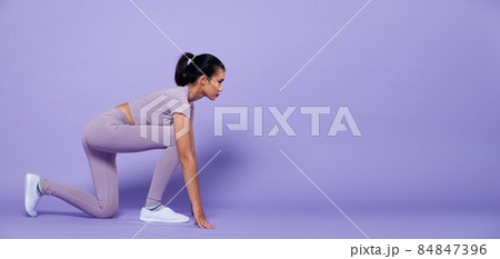 Full length Asian slim Fitness woman exercise warm up stretch spring jumps legs, peri purple Full length Asian slim Fitness woman exercise warm up stretch spring jumps legs, peri purple 84847396