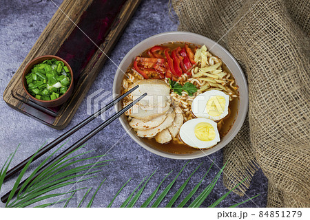 hot delicious japanese noodle soup ramen with chicken vegetables, green onions and egg with chopsticks hot delicious japanese noodle soup ramen with chicken vegetables, green onions and egg with chopsticks 84851279