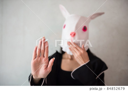 Girl with rabbit mask show stop talk hand sign Girl with rabbit mask show stop talk hand sign 84852679