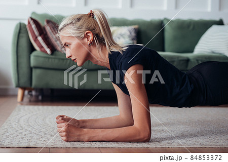 Young woman doing plank exercise at home. Young woman doing plank exercise at home. 84853372