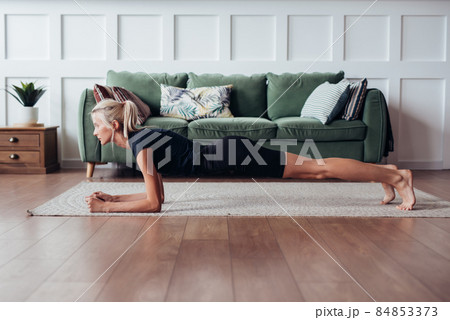 Young woman doing plank exercise at home. Young woman doing plank exercise at home. 84853373
