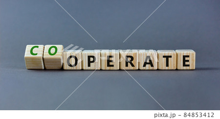 Operate and cooperate symbol. Turned wooden cubes and changed the word operate to cooperate. Beautiful grey table, grey background. Operate, cooperate and business concept. Copy space. 84853412
