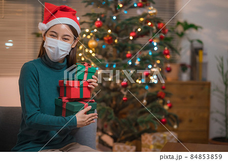 Woman celebrate christmas and new year during corona virus outbreak 84853859