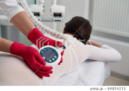 Beautiful woman getting beauty cellulite therapy Beautiful woman getting beauty cellulite therapy 84854233