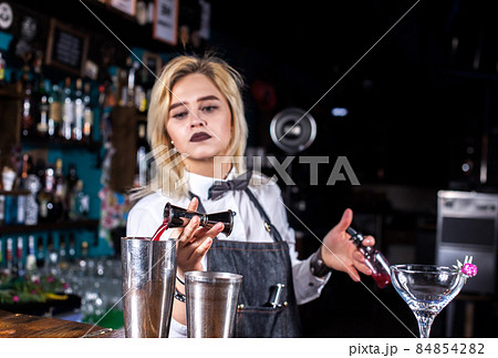 Girl barman makes a cocktail in the brasserie Girl barman makes a cocktail in the brasserie 84854282