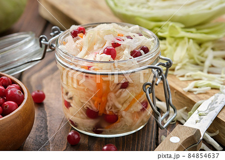 Jar of sour cabbage, pickled sauerkraut.  Fermented cabbage  with cranberries, coleslaw salad. Healthy food, diet food. 84854637
