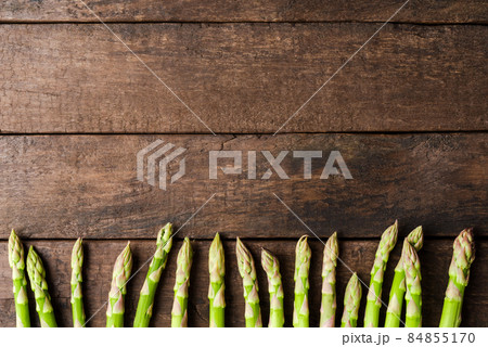 Green asparagus on wooden background with copyspace Green asparagus on wooden background with copyspace 84855170