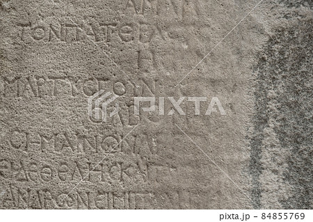 almost erased ancient Greek inscription on the stone almost erased ancient Greek inscription on the stone 84855769