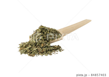 Dried Lemon balm (Melissa officinalis) herb on wooden spoon isolated on white background. Dried Lemon balm (Melissa officinalis) herb on wooden spoon isolated on white background. 84857403
