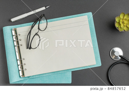 Medical folder with glasses on black background 84857652