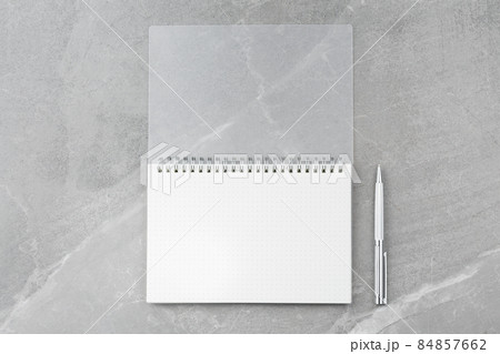 Notepad with a pen on a marble background. 84857662