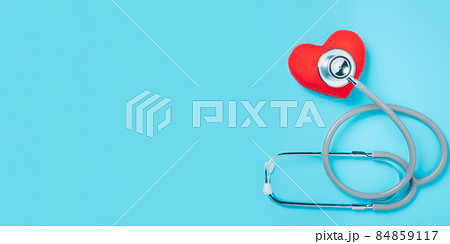 Red heart with stethoscope on blue background with copy space, heart health, health insurance concept, World heart day, world health day Red heart with stethoscope on blue background with copy space, heart health, health insurance concept, World heart day, world health day 84859117