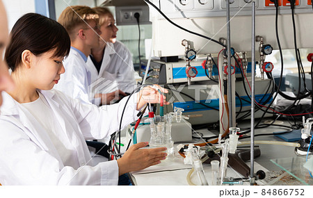 Students performing experiments in laboratory Students performing experiments in laboratory 84866752