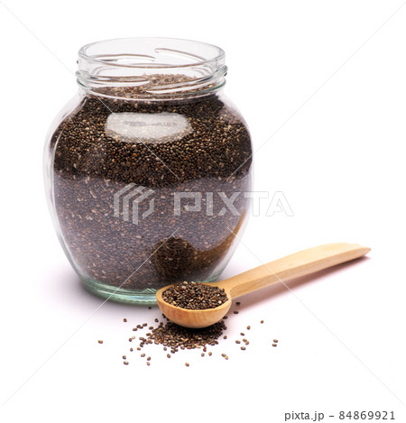 glass can full of organic natural chia seeds close-up isolated on white background 84869921
