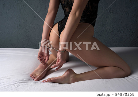Sexual bdsm toy. Woman with hands tied.  84870259