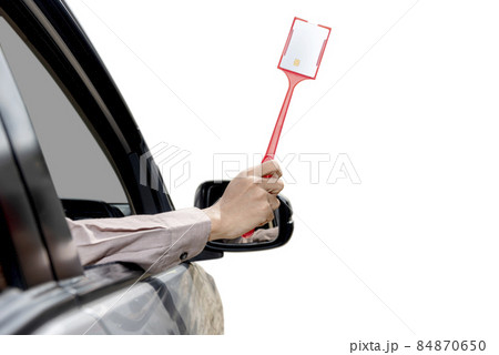 Man hand from inside the car take out the card to pay the toll 84870650