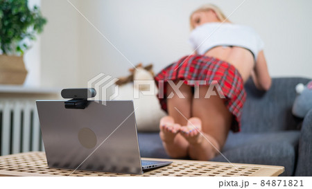 Faceless young woman dressed in schoolgirl costume for online sex. The web model is dancing twerk to the camera Faceless young woman dressed in schoolgirl costume for online sex. The web model is dancing twerk to the camera 84871821