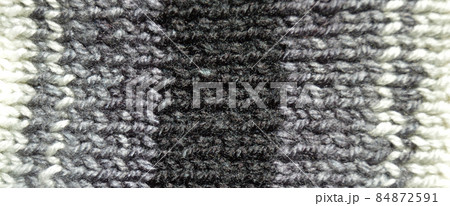 Handmade knitted fabric grey wool background texture Handmade knitted fabric grey wool background texture 84872591