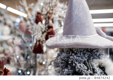 Different object toy gifts hanging from a decorated Christmas tree. Different object toy gifts hanging from a decorated Christmas tree. 84874242