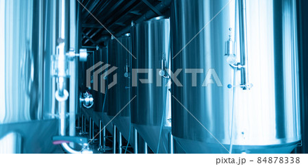 Manometers on steel cylinder storages or vats or tanks on beer and cider production plant, industry machine equipment 84878338