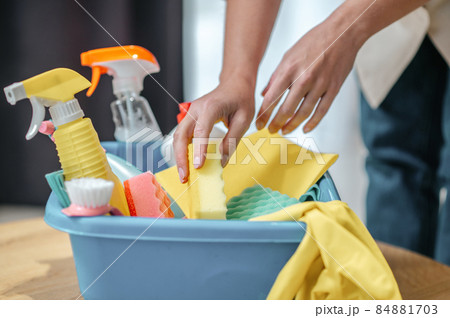 Close up picture of hands taling something from the box with cleaning supplies Close up picture of hands taling something from the box with cleaning supplies 84881703