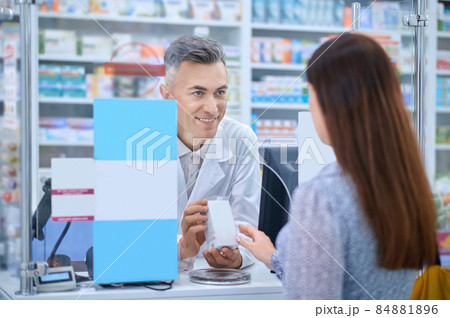 Female client standing near the pharmacy counter 84881896