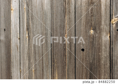 Old gray wood boards texture background. Weathered wooden wall with vertical planks. 84882250