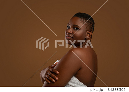 Portrait of beautiful plus size African American woman embracing herself Portrait of beautiful plus size African American woman embracing herself 84883505