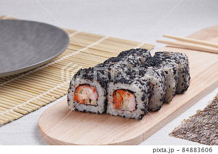 a portion of rolls on a stand, japanese food, sushi on the table, chinese chopsticks, light background a portion of rolls on a stand, japanese food, sushi on the table, chinese chopsticks, light background 84883606