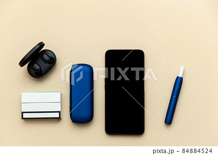 Iqos electronic blue cigarette on a beige background. 84884524