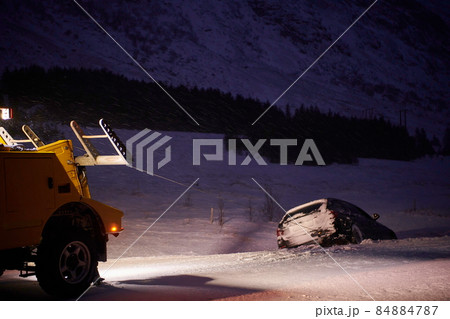 Car being towed after accident in snow storm 84884787
