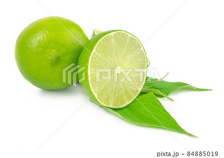 Half and whole lime isolated on white with leaves 84885019