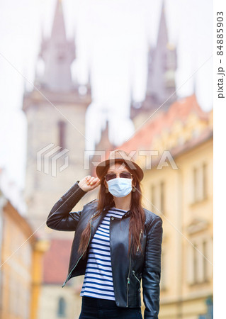 Happy young urban woman in european city on the famous bridge in Prague, Czech Republic. Caucasian tourist walking along the empty streets of Europe. Happy young urban woman in european city on the famous bridge in Prague, Czech Republic. Caucasian tourist walking along the empty streets of Europe. 84885903