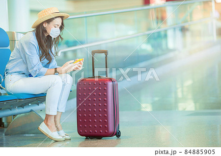 Young tourist woman with baggage in international airport Young tourist woman with baggage in international airport 84885905