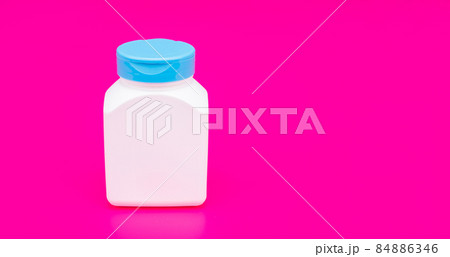 presenting vitamin product. white unbranded pill jar. multivitamin bottle on pink background. presenting vitamin product. white unbranded pill jar. multivitamin bottle on pink background. 84886346