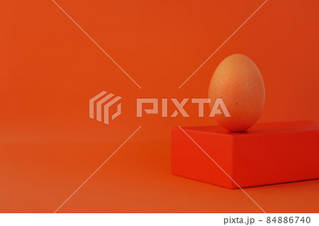 Easter egg on geometrical shape podium stage orange background Brown chicken egg balancing pedestal isometric minimalism Easter egg on geometrical shape podium stage orange background Brown chicken egg balancing pedestal isometric minimalism 84886740