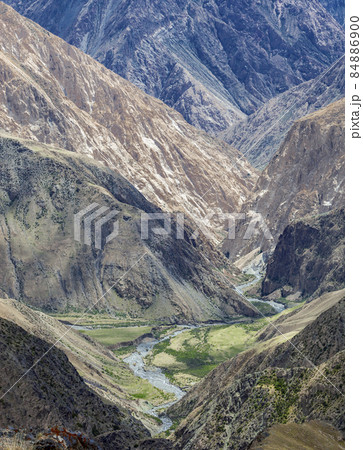 View of  closed gorge with steep rocky slopes in the autumn mountains. 84886900