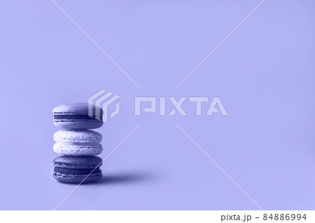 Three macaroons in stack toned in trendy color of year 2022. Trendy background for your design. Color 2022 concept. Food concept in vintage style. Copy space. Closeup. Three macaroons in stack toned in trendy color of year 2022. Trendy background for your design. Color 2022 concept. Food concept in vintage style. Copy space. Closeup. 84886994