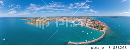 Drone panorama over the Croatian coastal town Novigrad with harbor and promenade taken from the sea side during the day Drone panorama over the Croatian coastal town Novigrad with harbor and promenade taken from the sea side during the day 84888268