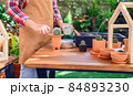 Planting cactus and growing tree. Home gardening and recreation activity at botanic garden. 84893230