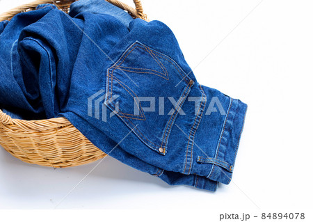 Blue jeans in laundry basket 84894078