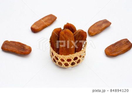 Sun dried bananas on white background. 84894120