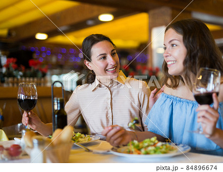 Couple enjoying dinner with wine at restaurant Couple enjoying dinner with wine at restaurant 84896674