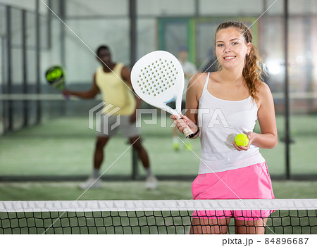 Young beautiful woman posing on padel court Young beautiful woman posing on padel court 84896687