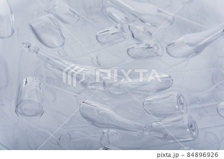 Glass medical ampoule vial for injection. Medicine is liquid sodium chloride with of aqueous solution in ampulla. Close up. Bottles ampule multicolor. 84896926