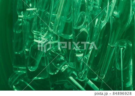 Glass medical ampoule vial for injection. Medicine is liquid sodium chloride with of aqueous solution in ampulla. Close up. Bottles ampule multicolor. Glass medical ampoule vial for injection. Medicine is liquid sodium chloride with of aqueous solution in ampulla. Close up. Bottles ampule multicolor. 84896928
