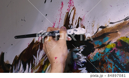 Artist designer draws an eagle on the wall. Craftsman decorator paints a picture with acrylic oil color brush. Close-up dark magic cinematic look. Artist designer draws an eagle on the wall. Craftsman decorator paints a picture with acrylic oil color brush. Close-up dark magic cinematic look. 84897081