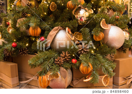 New Year's card. Christmas tree, decorated in an ecological style. The tree is decorated with dried citrus fruits. Trend. New Year's card. Christmas tree, decorated in an ecological style. The tree is decorated with dried citrus fruits. Trend. 84898460
